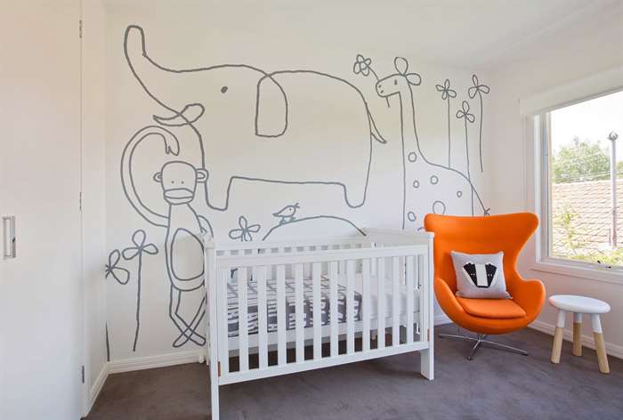 Doodle artwork on wall of baby nursery.