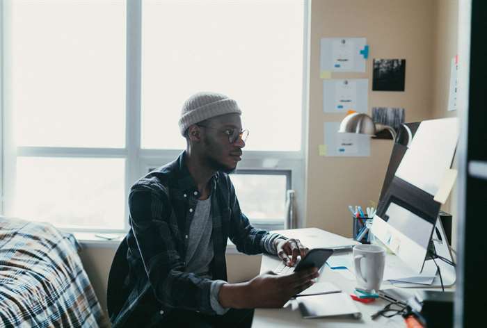 College student working at desk. 