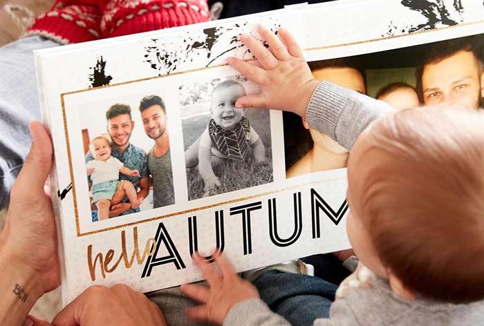 Baby looking at photo book.