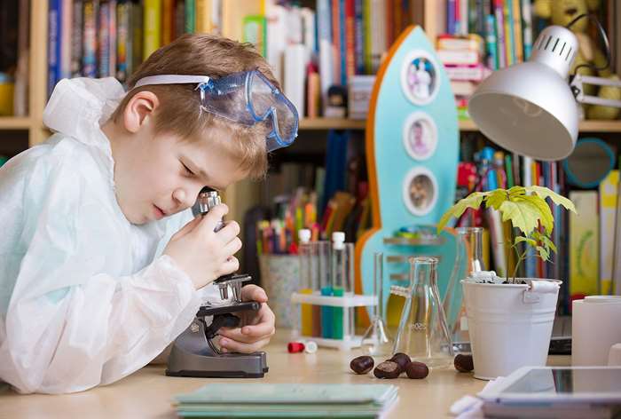 Boy looking through microscope.