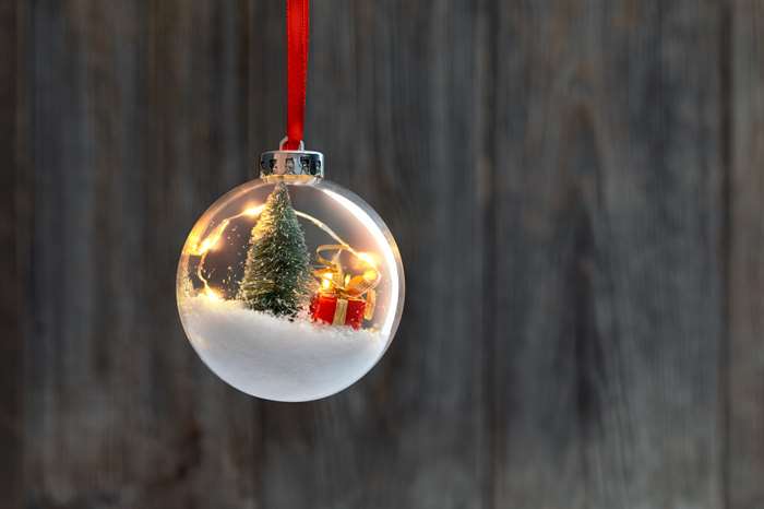 Clear Ball Ornament with christmas tree, small gift and christmas light inside.