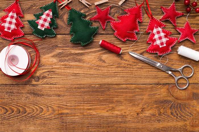 Handmade Christmas felt ornaments on a DIY background.