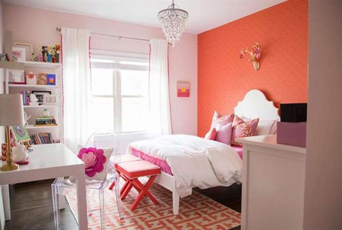 Pink girls bedroom with glass chandelier.