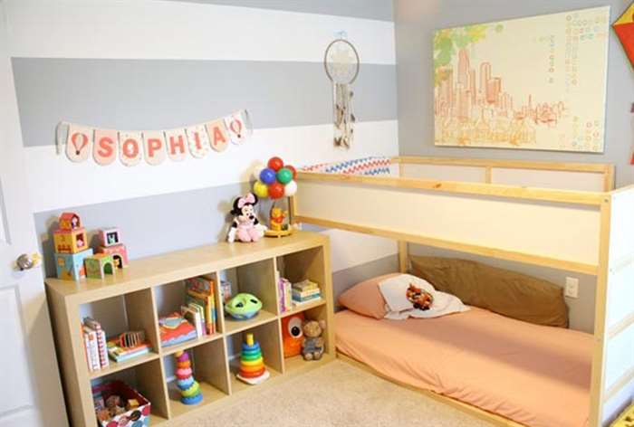 Bunk beds and toy shelves in little girls bedroom.