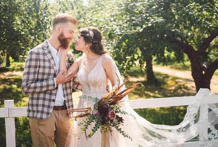 Married couple kissing outside.