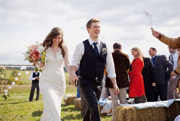 Married couple walking back down the aisle.