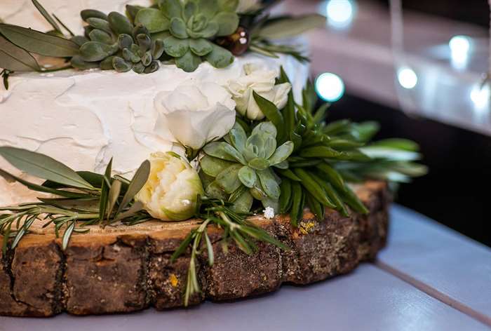 Wedding cake base with greenery.