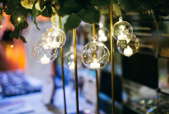 Round glass hanging lanterns with tea candles.