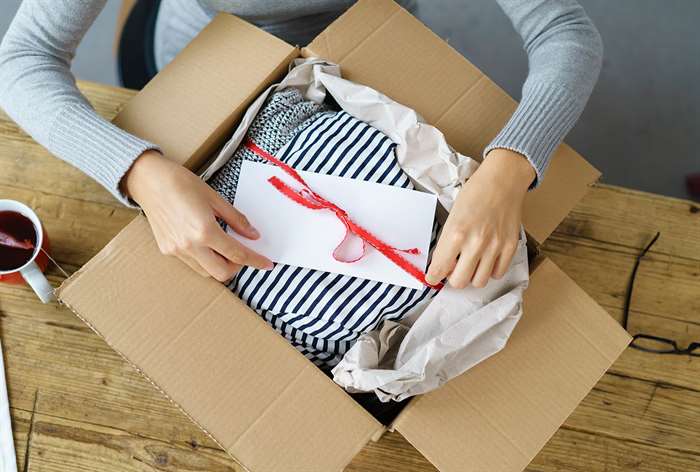 Woman opening box.