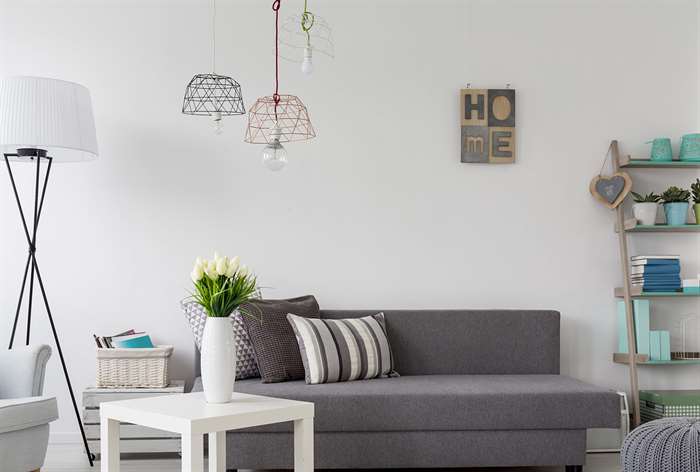 Geometric lamps hanging over sofa.