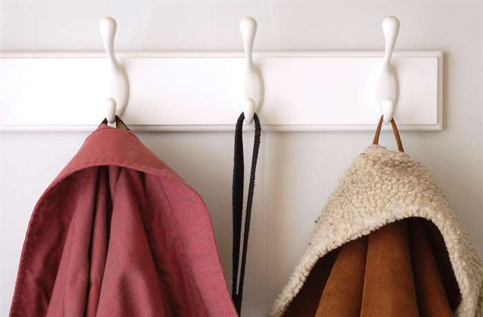 white wall hooks hanging clothes