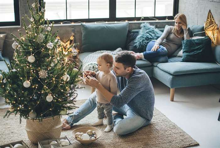 Family around small Christmas tree.