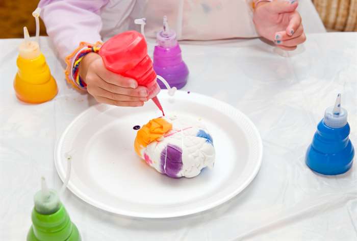 Kid tie dying a white shirt. 