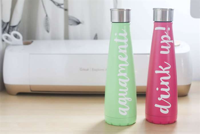 pink and green water bottles with cursive sayings