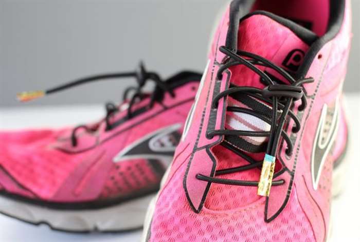 pink running shoes with gold lace tips