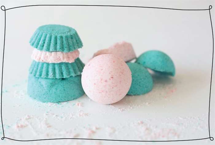 Bath bombs in pink and turquoise are stacked