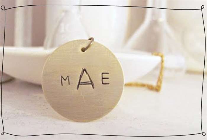 Stamped metal pendant with initials on it