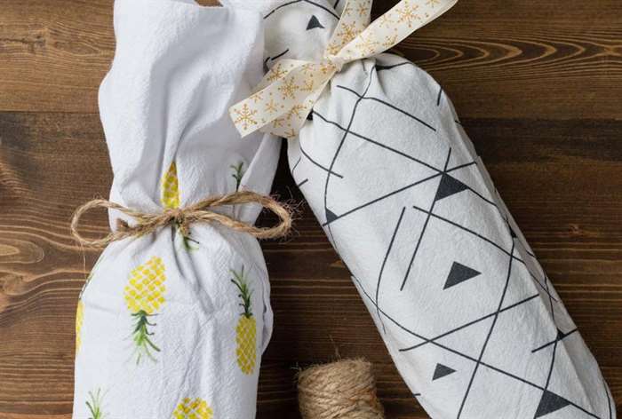 bottles wrapped in a patterned tea towel and tied with twine