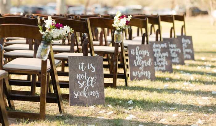 wooden signs love is poem down aisle