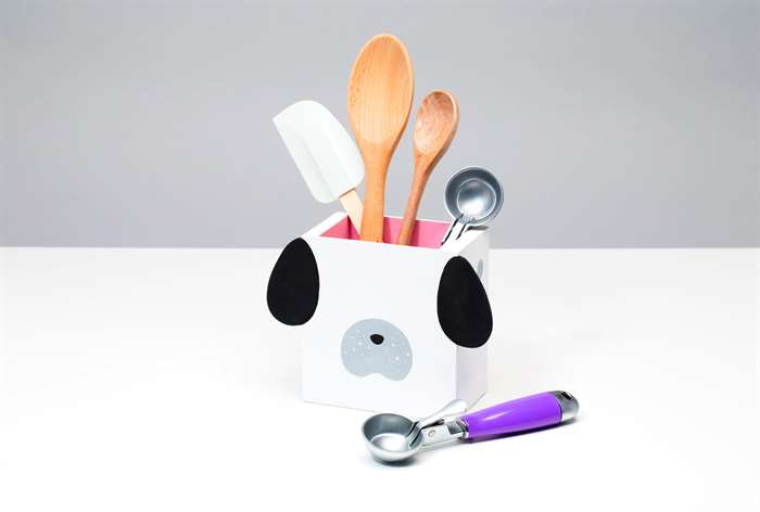 dog utensil holder with some utensils in it