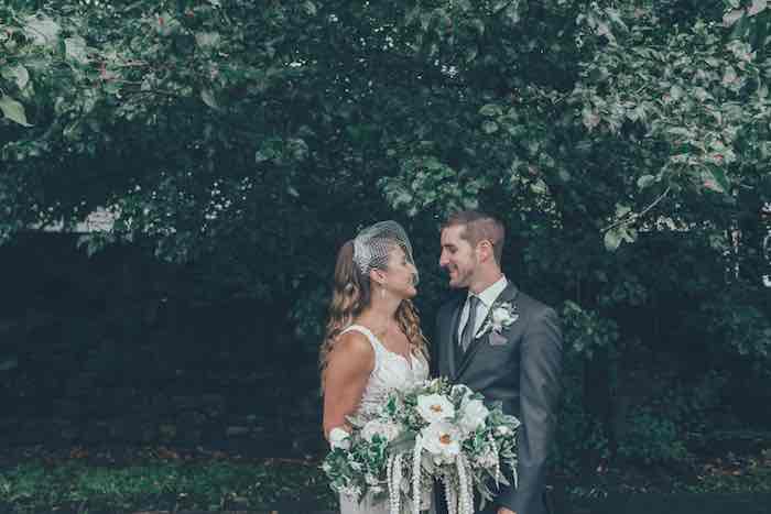 bride and groom looking into each other's eyes in beautiful nature surrounding