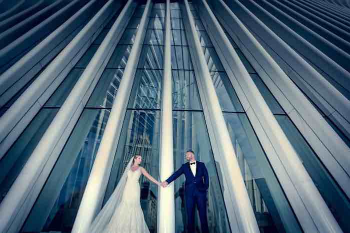 bride and groom in front of skyscraper