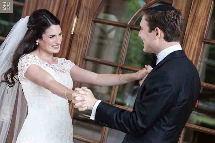 bride and groom smiling at each other