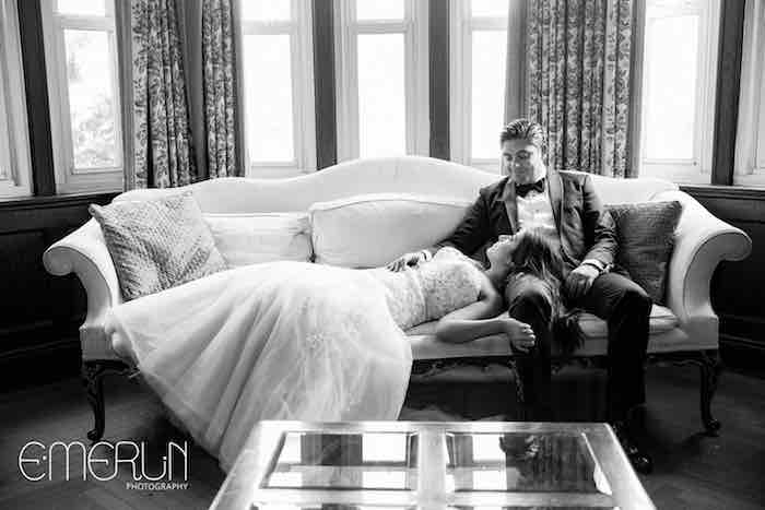 bride and groom laying on a couch