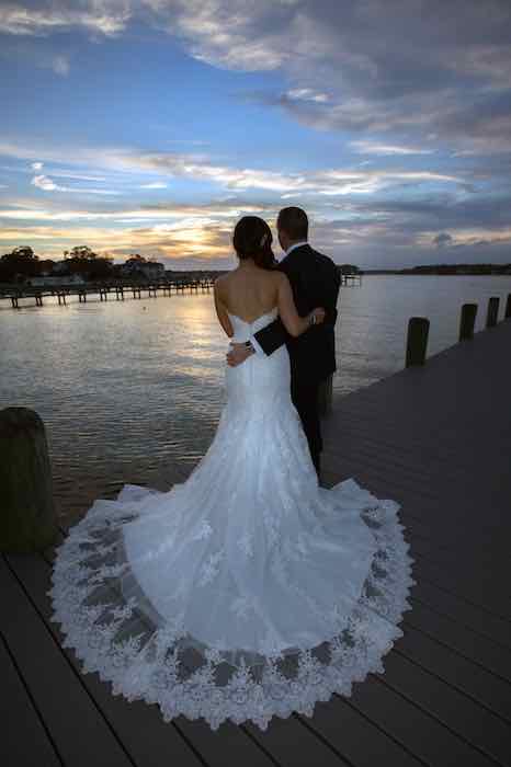 bride and groom looking out over the shore