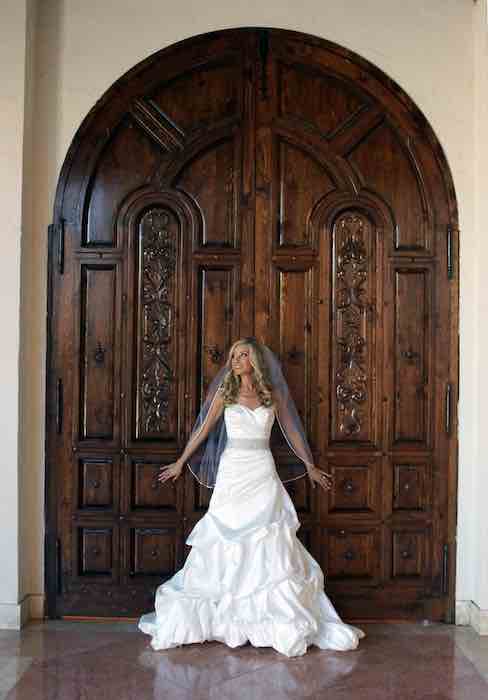 bride standing in front of double doors
