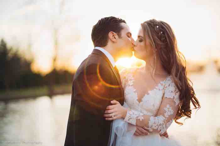 couple kissing and sun flare