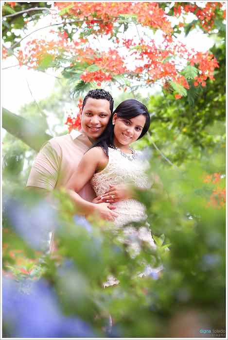 bride and groom posing in flowers