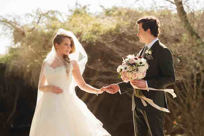 sunlight bride and groom holding hands