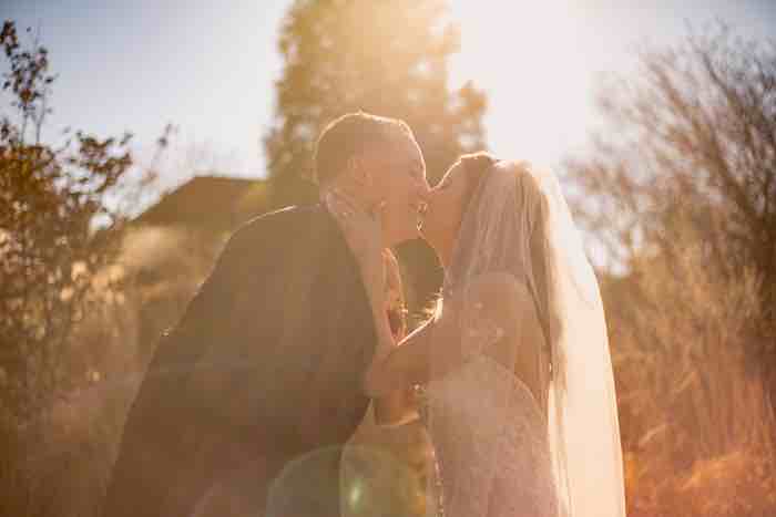 bride and groom under natural sunlight
