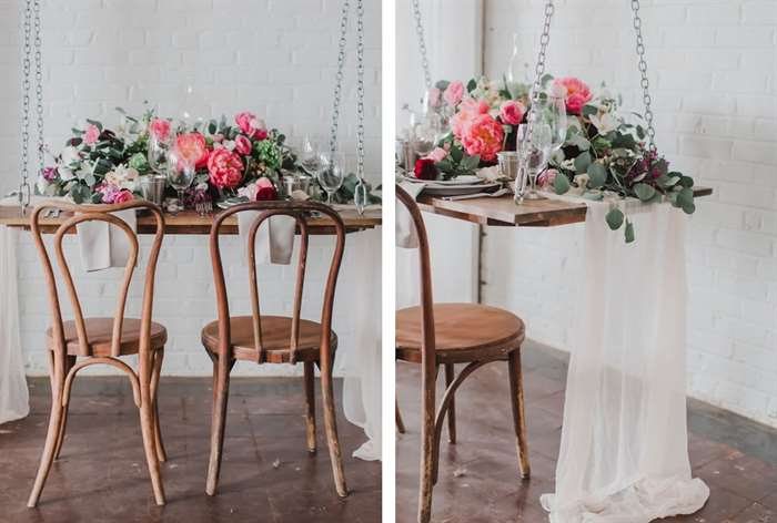 Hanging sweetheart table with pink floral arrangement 