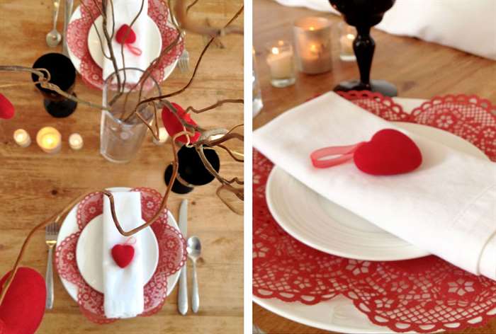 Wooden table with white plates and red heart accents