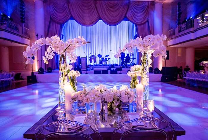 Table with different sizes of white flower arrangements