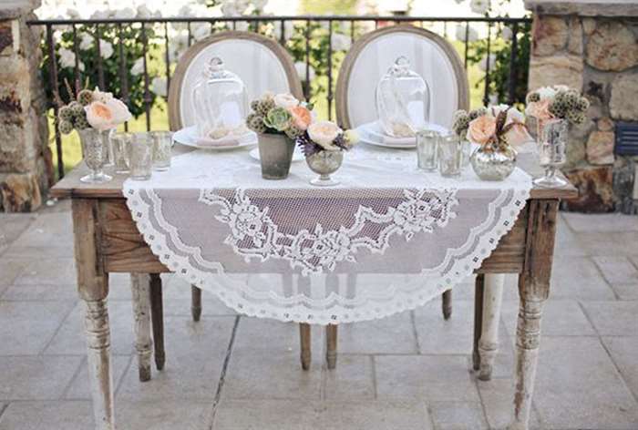 Simple wooden table with white lace tablecloth