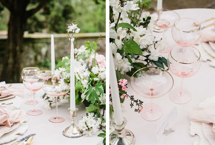 Table with white flowers and blush glassware accents