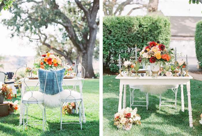 Orange and yellow flowers on a white table with fur blanket and denim pillow