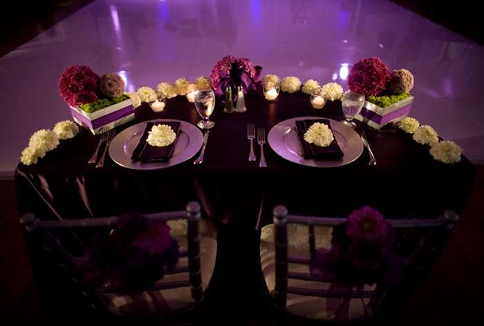 Dark purple table with white and purple flowers 