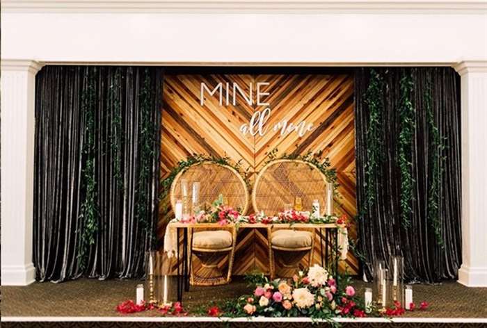 Wicker chairs and wooden table with tropical floral accents