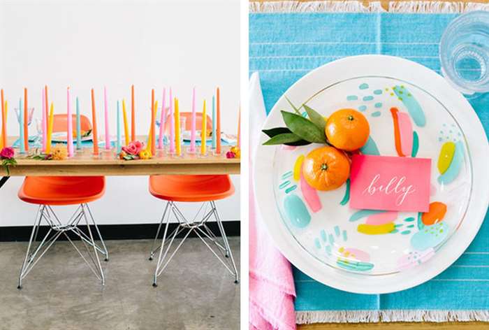 Table with brightly colored candles and chairs and clementine accents