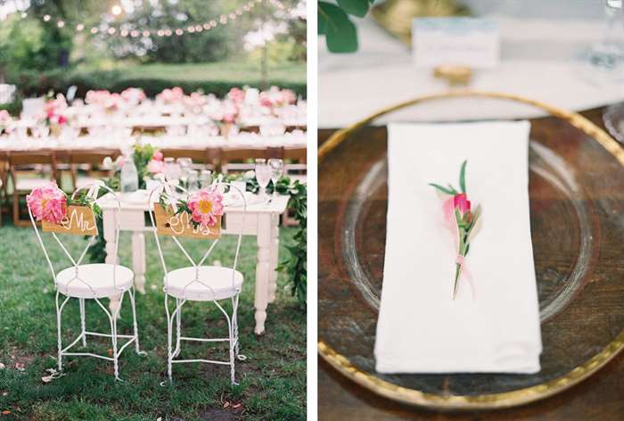 Simple white table and chairs with draping greenery and pink flowers