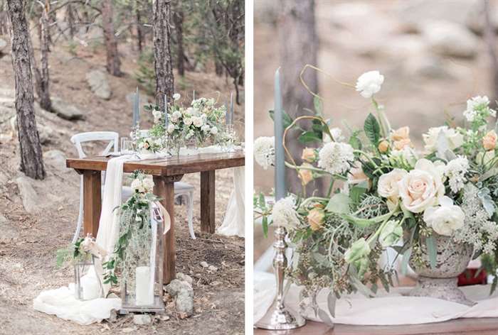 Wood table with white drapery and flowers and large lanterns