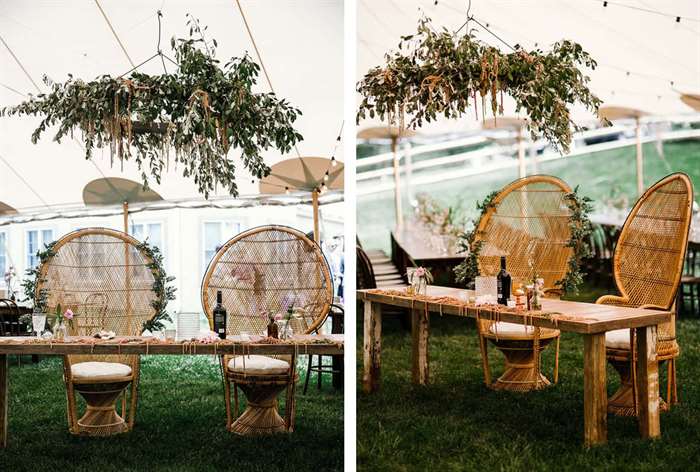 Simple wood table with wicker chairs and hanging greenery 