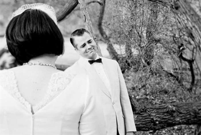 Groom looking at bride in black and white