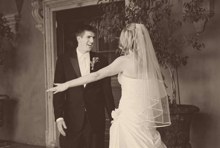 Bride extending her arms with a happy groom