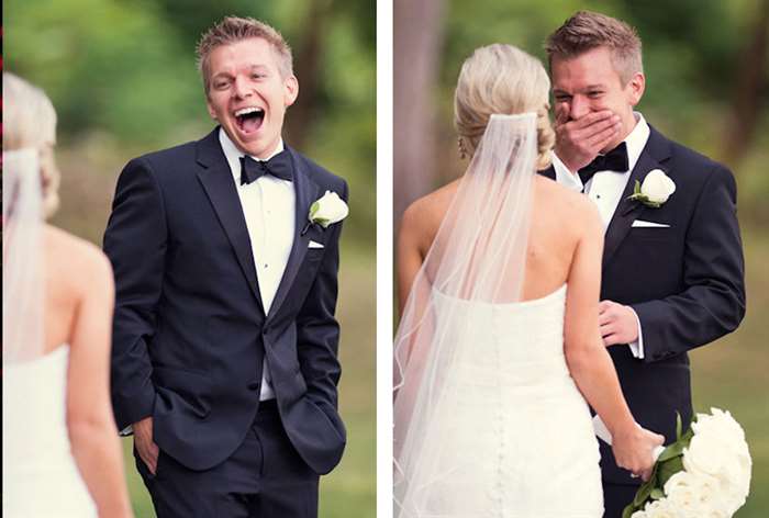 Groom gasping and covering mouth while looking at bride