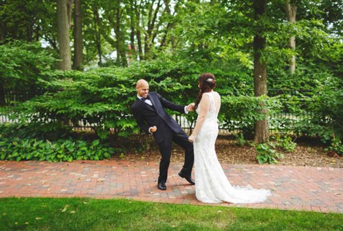 Groom showing his excitement towards his bride's wedding dress